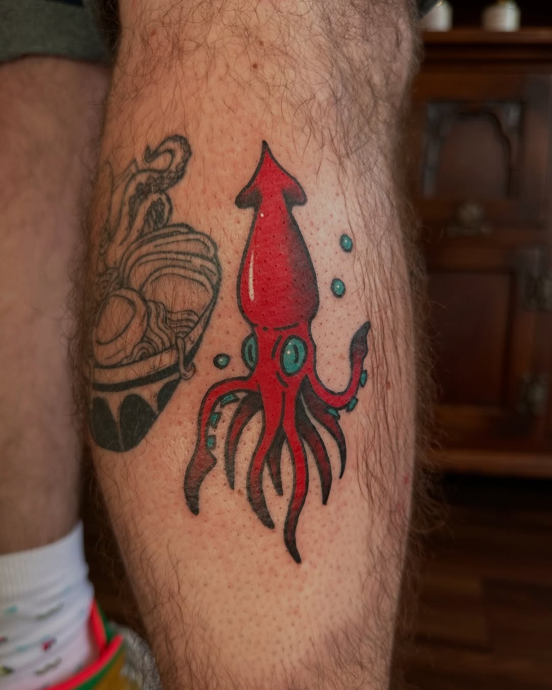 Vibrant squid tattoo on the lower leg Tattoo Design