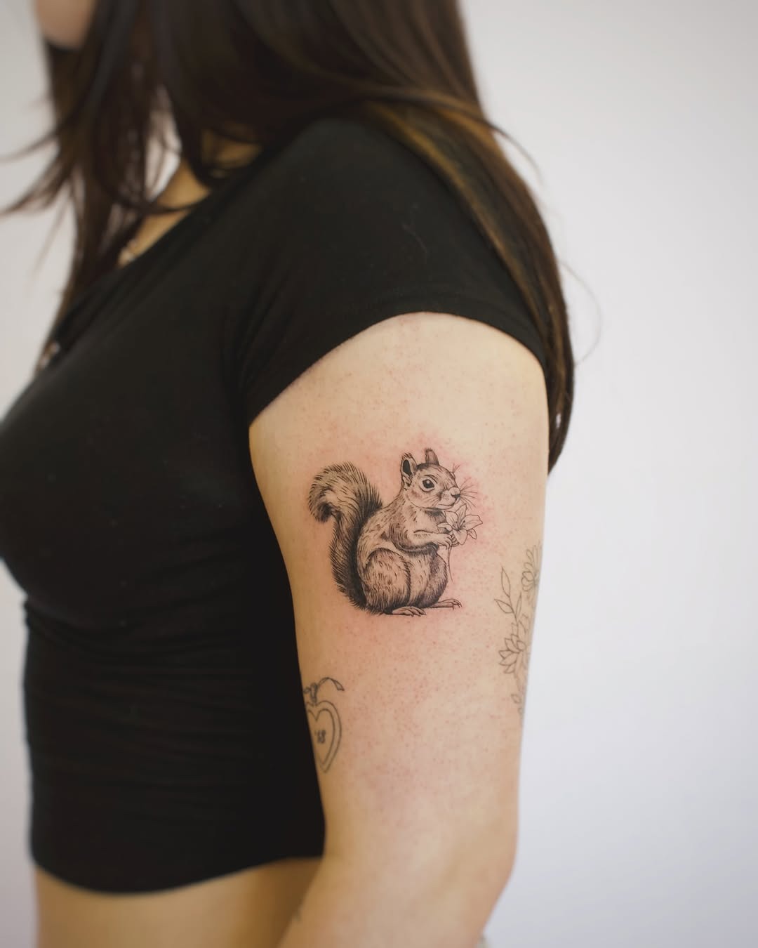 Charming Squirrel Tattoo on Woman’s Arm Tattoo Design