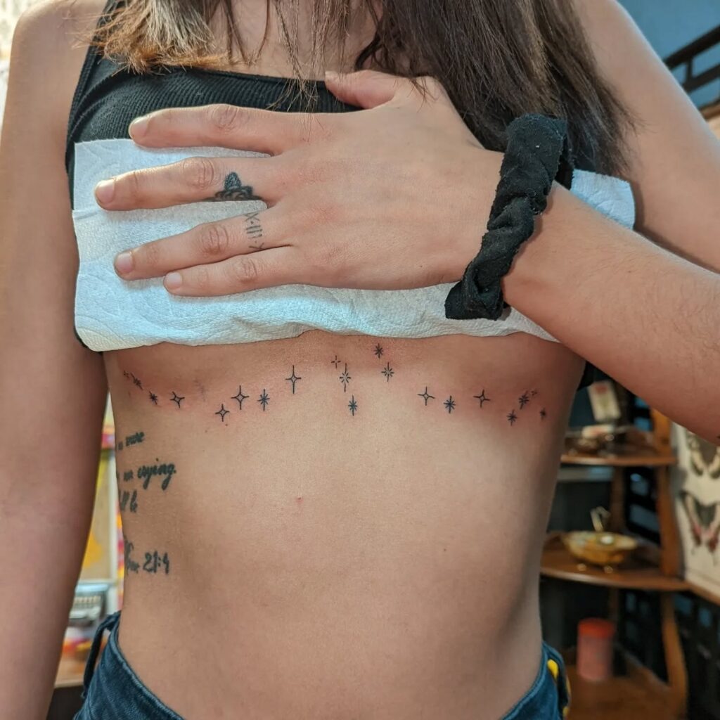 Scattered Star Under-Bust Tattoo Tattoo Design