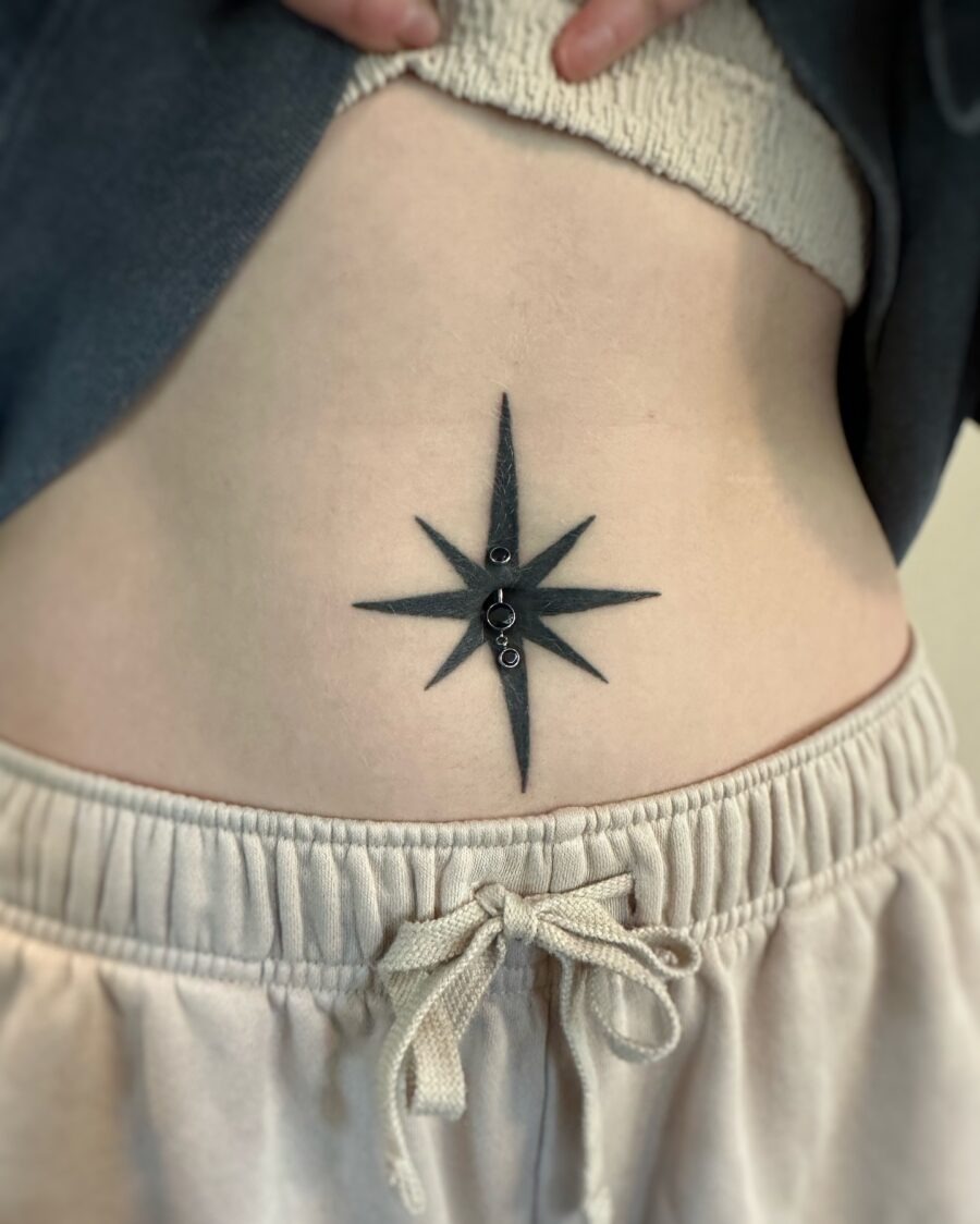 Bold star tattoo accentuating the stomach Tattoo Design