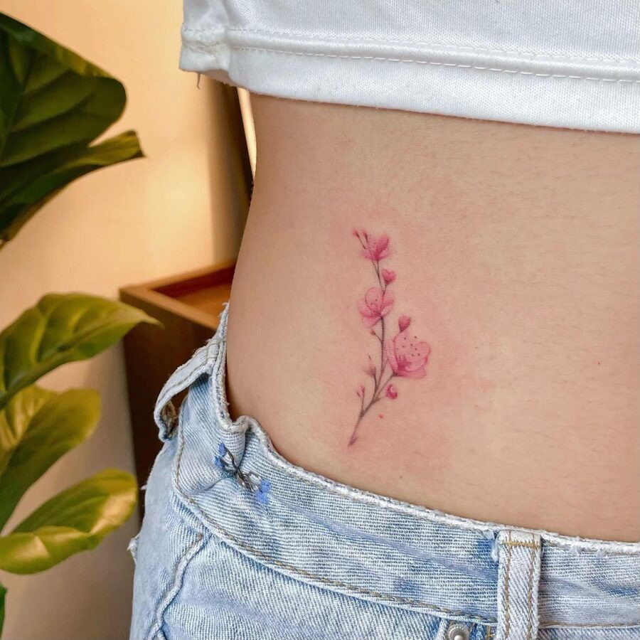 Delicate pink floral stomach tattoo design Tattoo Design