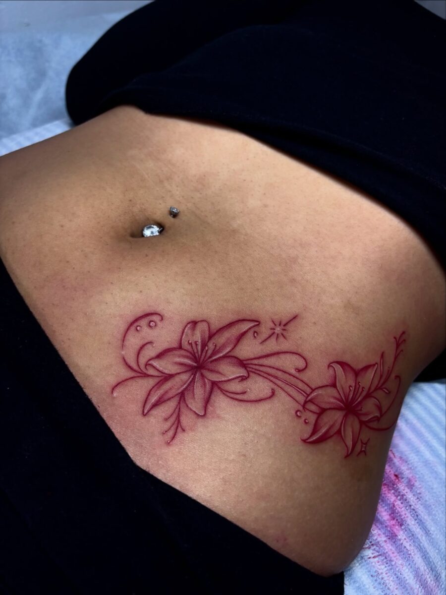 Elegant floral stomach tattoo in vibrant red Tattoo Design