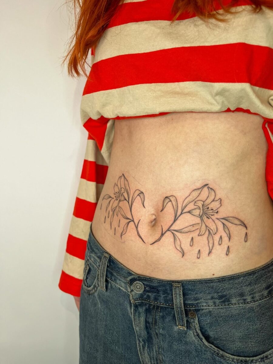 Elegant floral stomach tattoo with a unique design Tattoo Design