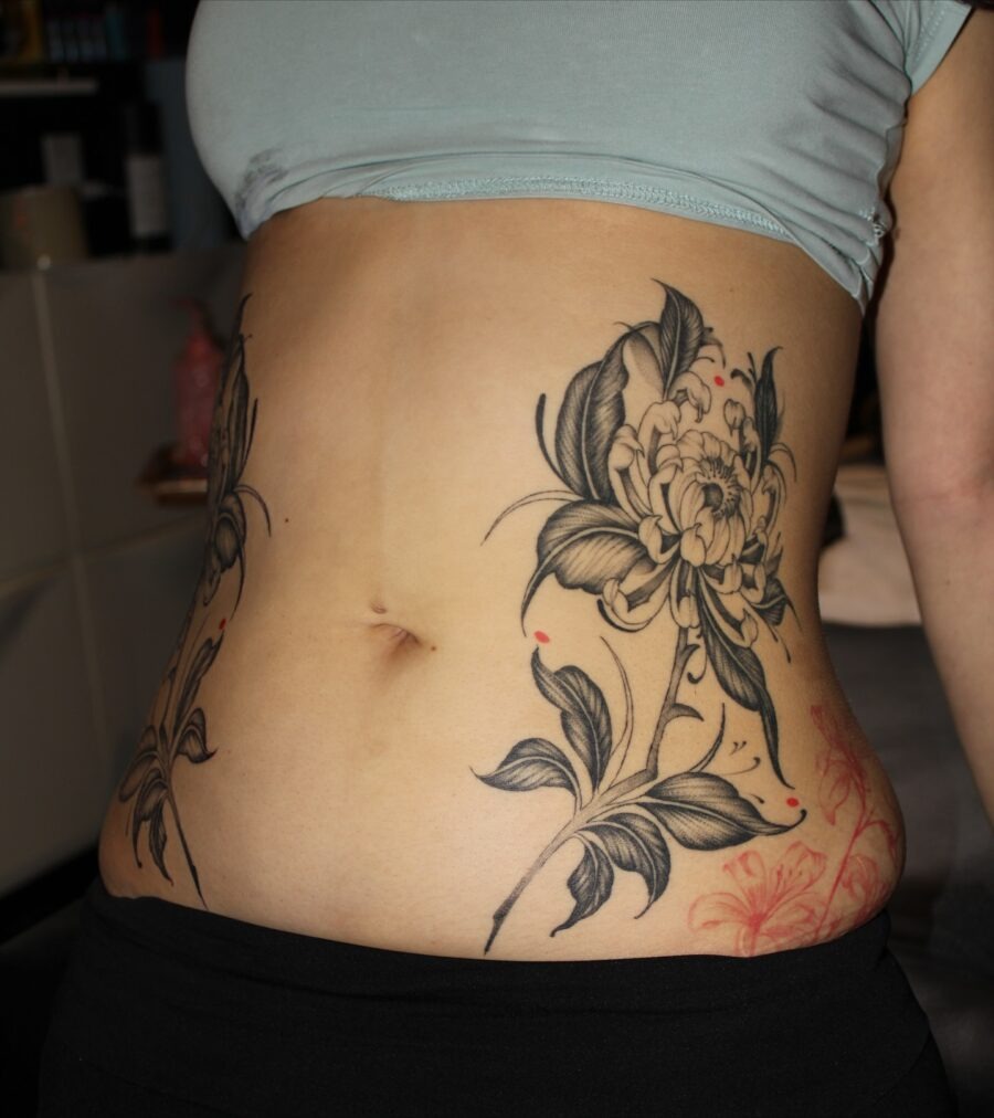 Elegant floral stomach tattoo with bold lines Tattoo Design