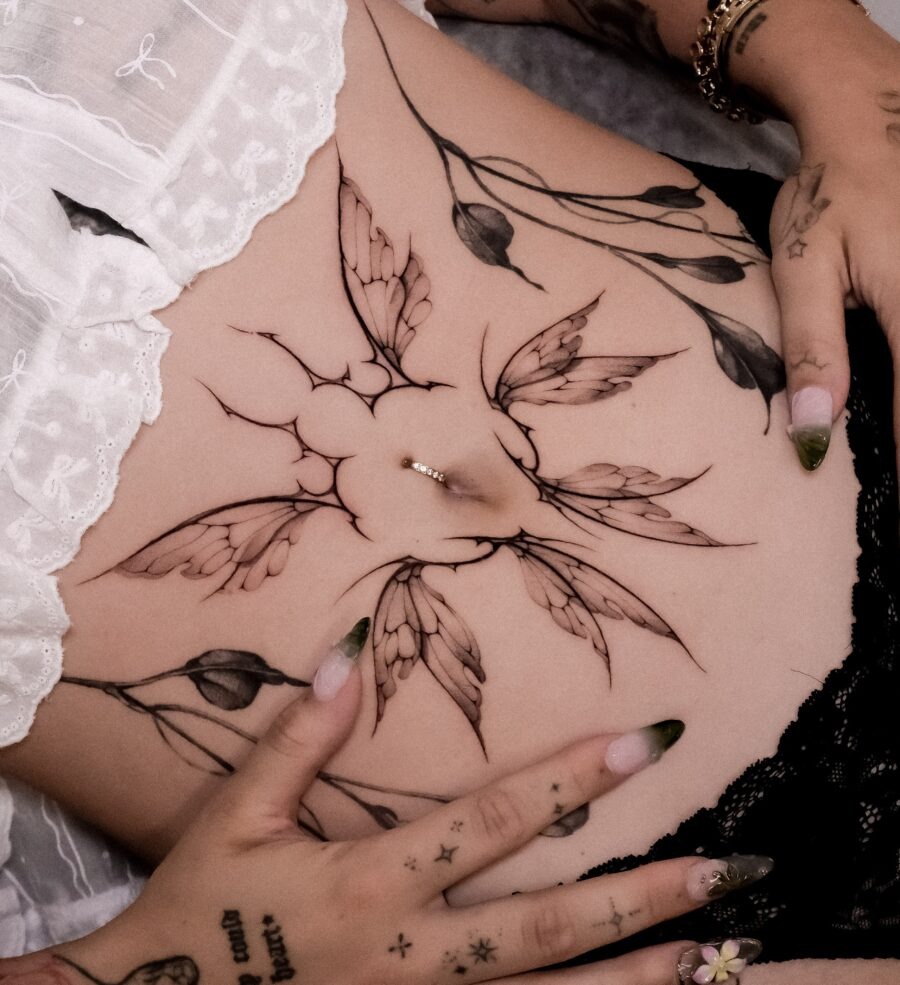 Elegant floral stomach tattoo with delicate details Tattoo Design