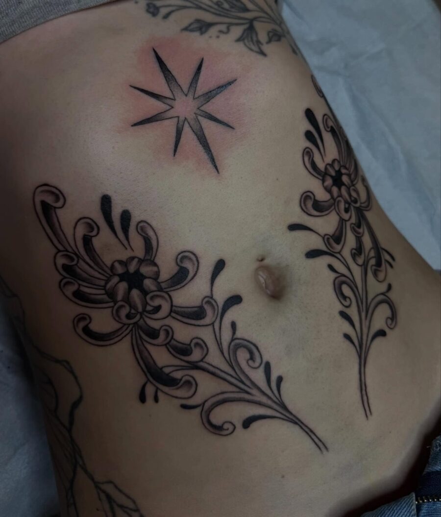 Elegant floral stomach tattoo with star detail Tattoo Design