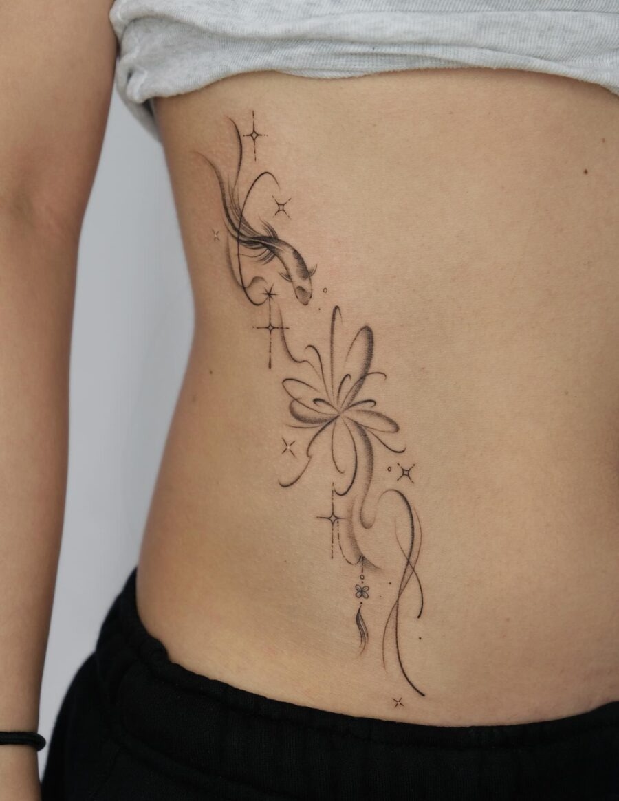 Elegant stomach tattoo with floral and star designs Tattoo Design