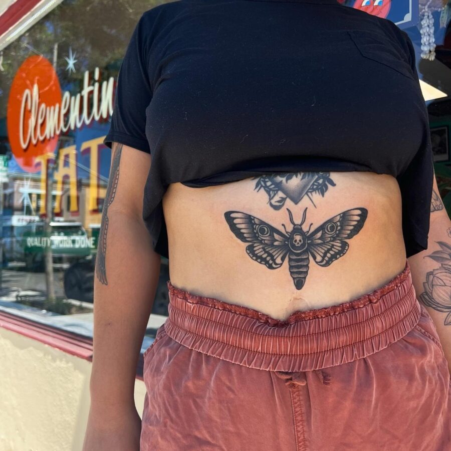 Intricate stomach tattoo featuring a striking moth. Tattoo Design