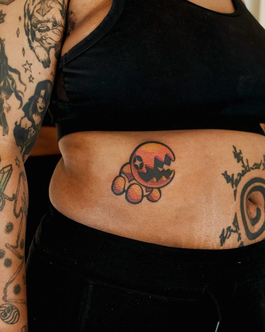 Playful cartoon-inspired stomach tattoo design Tattoo Design