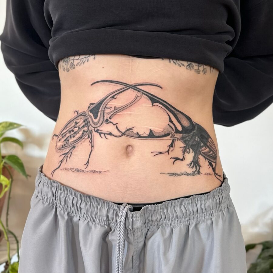 Stunning insect tattoo highlights midsection beauty Tattoo Design