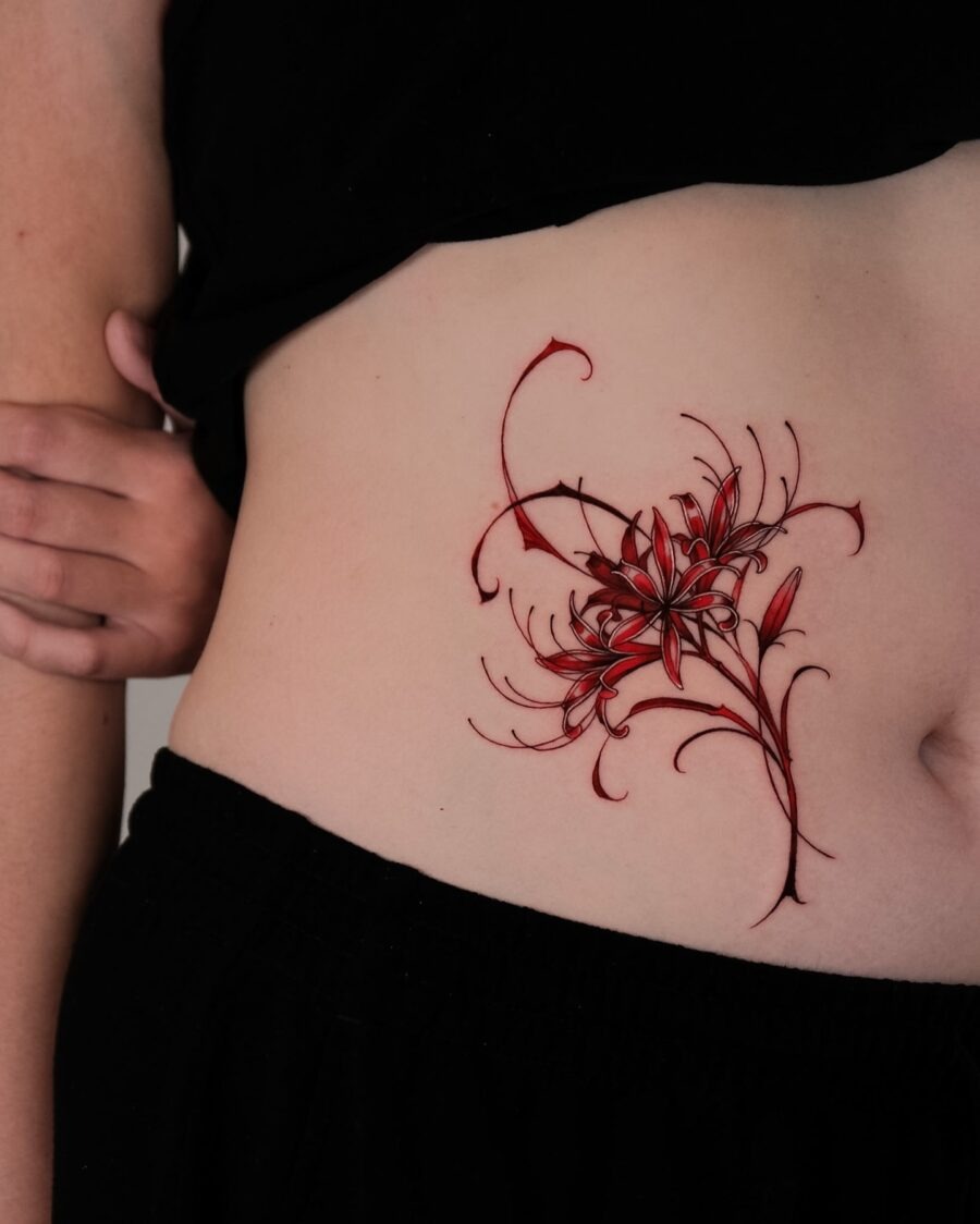 Vibrant floral stomach tattoo in red hues Tattoo Design