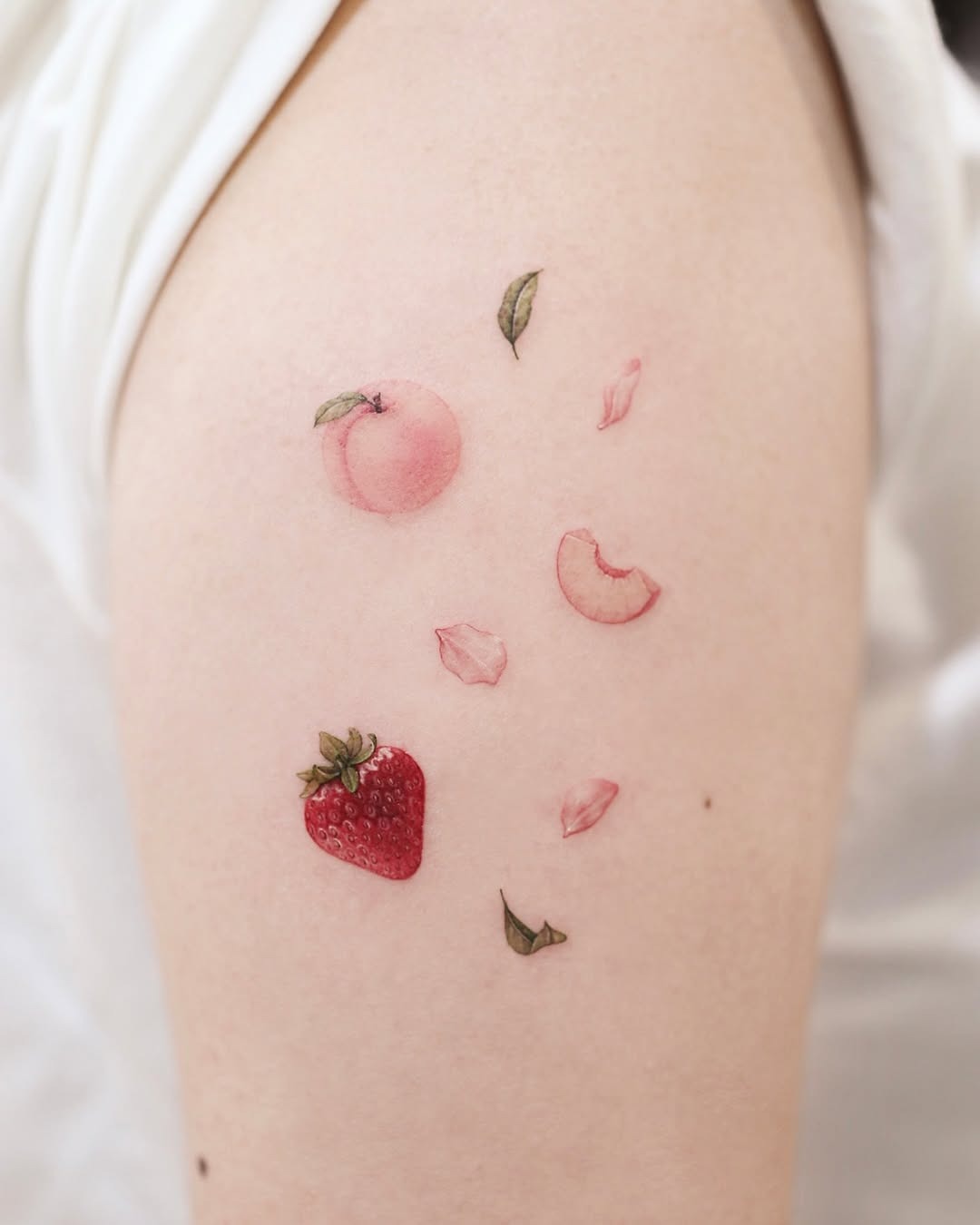 Charming strawberry tattoo with floral accents Tattoo Design