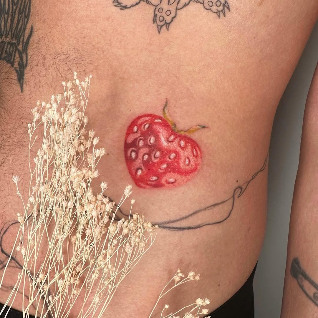 Colorful strawberry tattoo on the side body Tattoo Design
