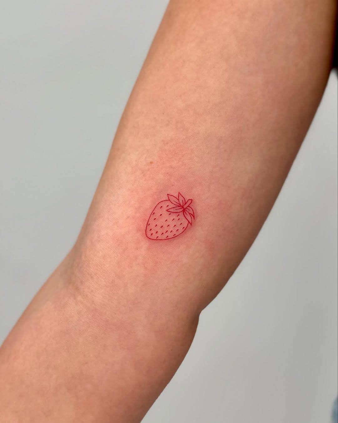 Minimalist Strawberry Tattoo in Red Ink Tattoo Design