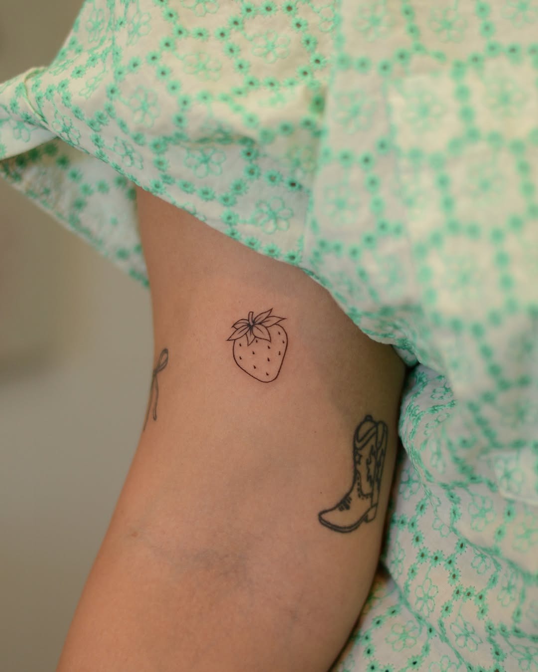 Minimalistic strawberry tattoo on inner arm Tattoo Design