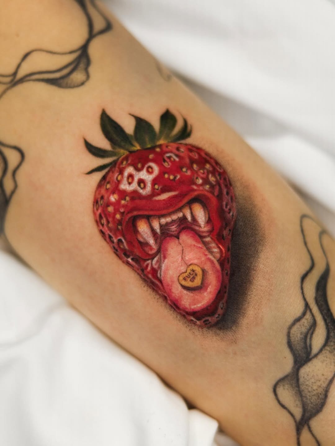 Unique strawberry tattoo with playful elements Tattoo Design