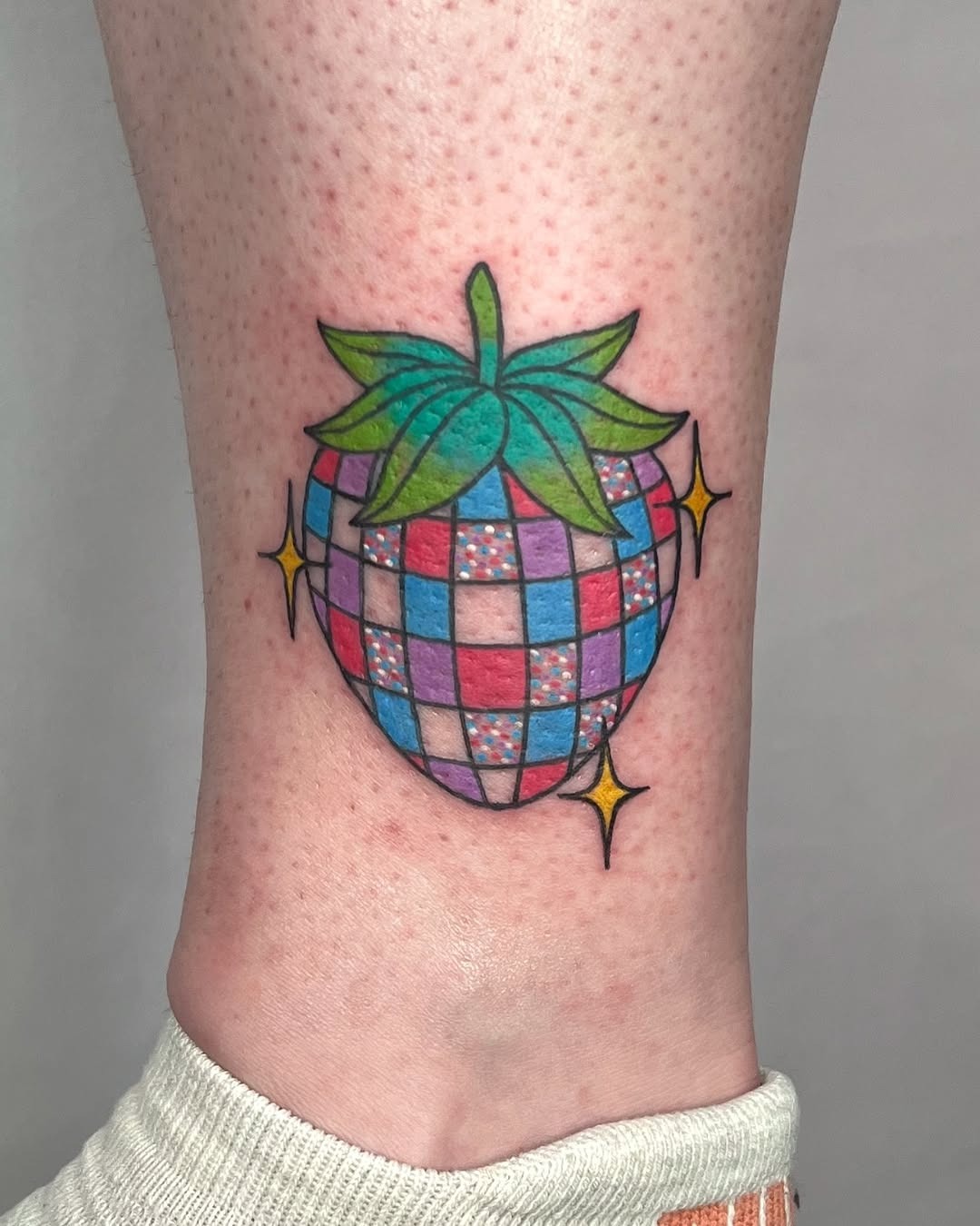 Vibrant disco-themed strawberry tattoo design Tattoo Design