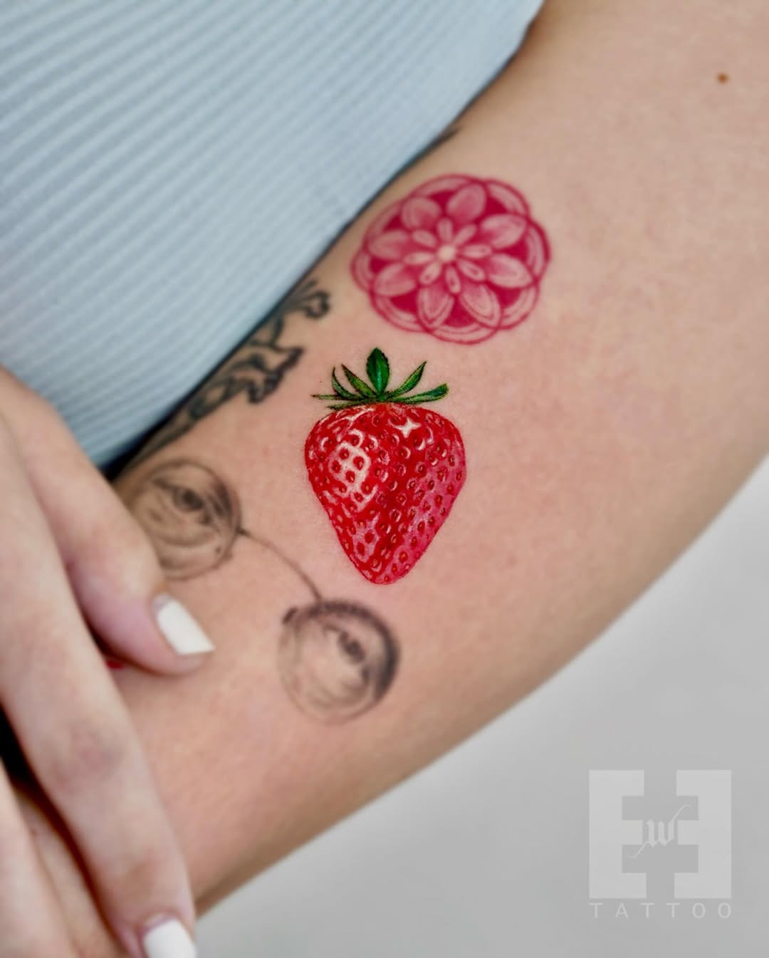 Vibrant strawberry and floral tattoo duo Tattoo Design