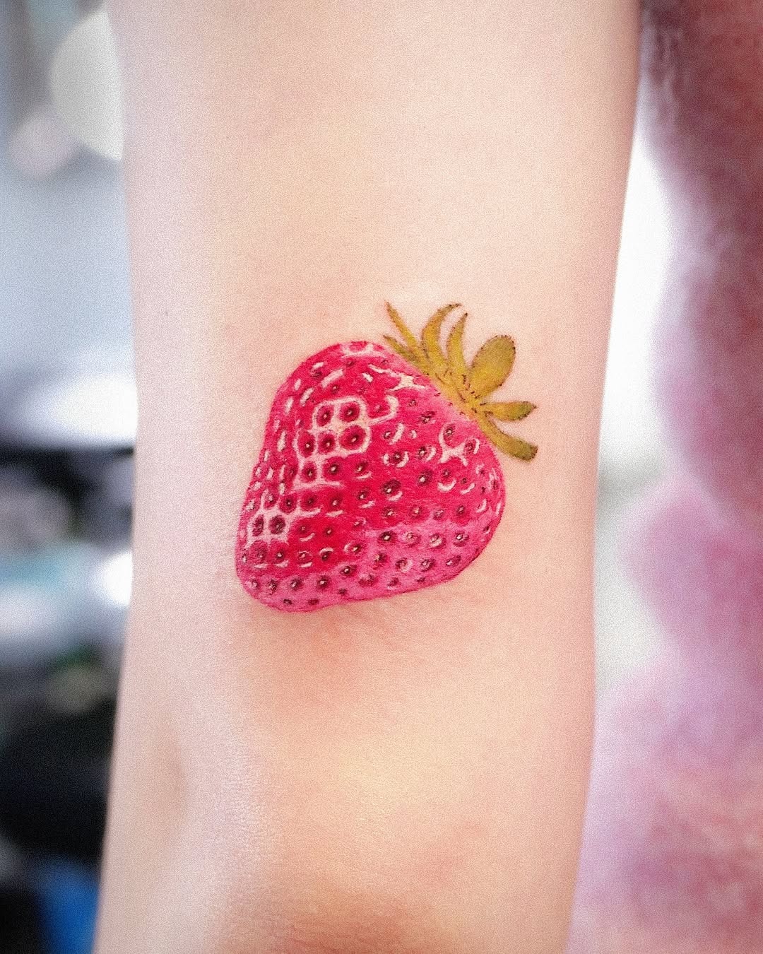 Vibrant Strawberry Tattoo on Display Tattoo Design