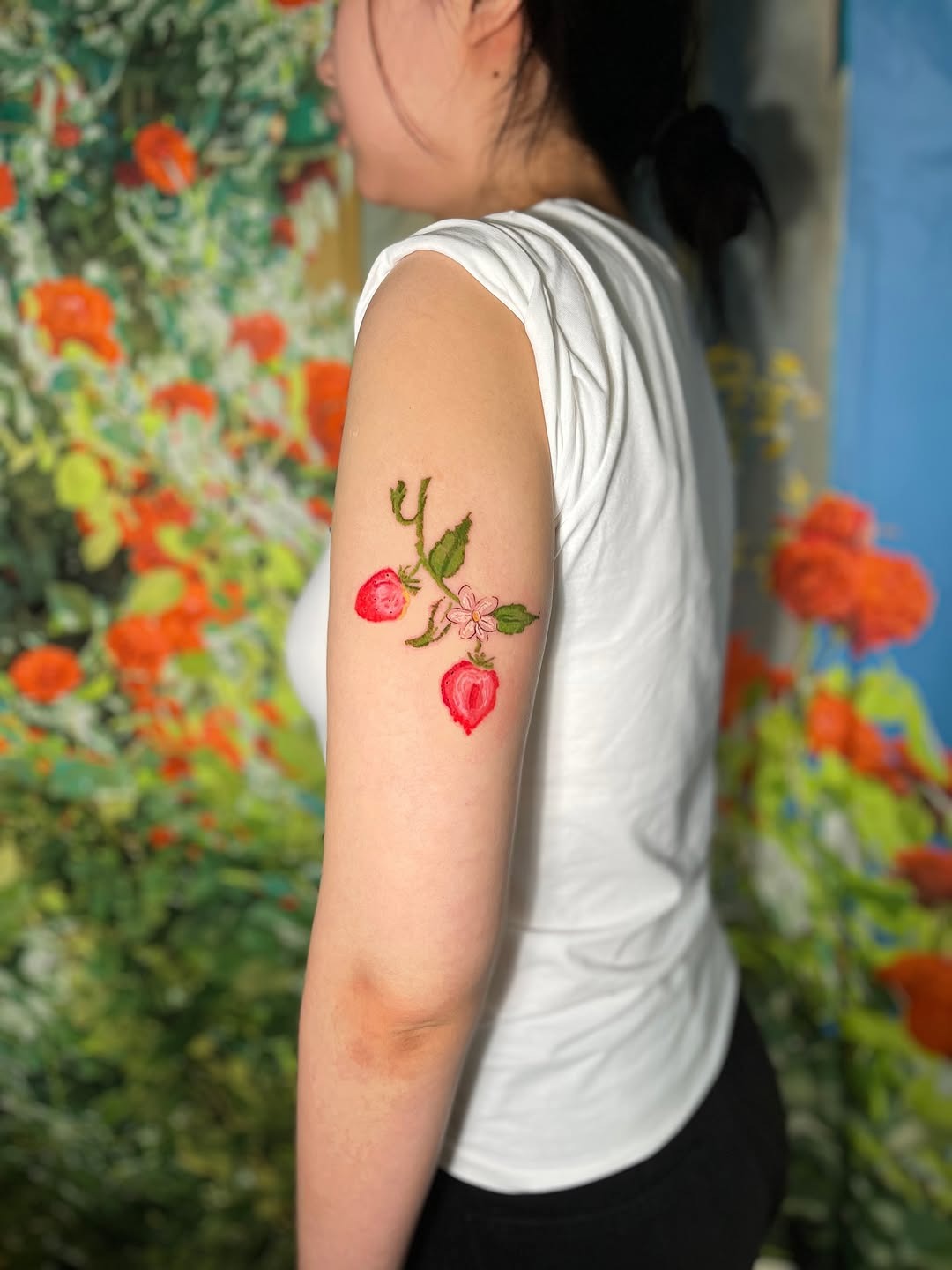 Vibrant strawberry tattoo with floral accents Tattoo Design