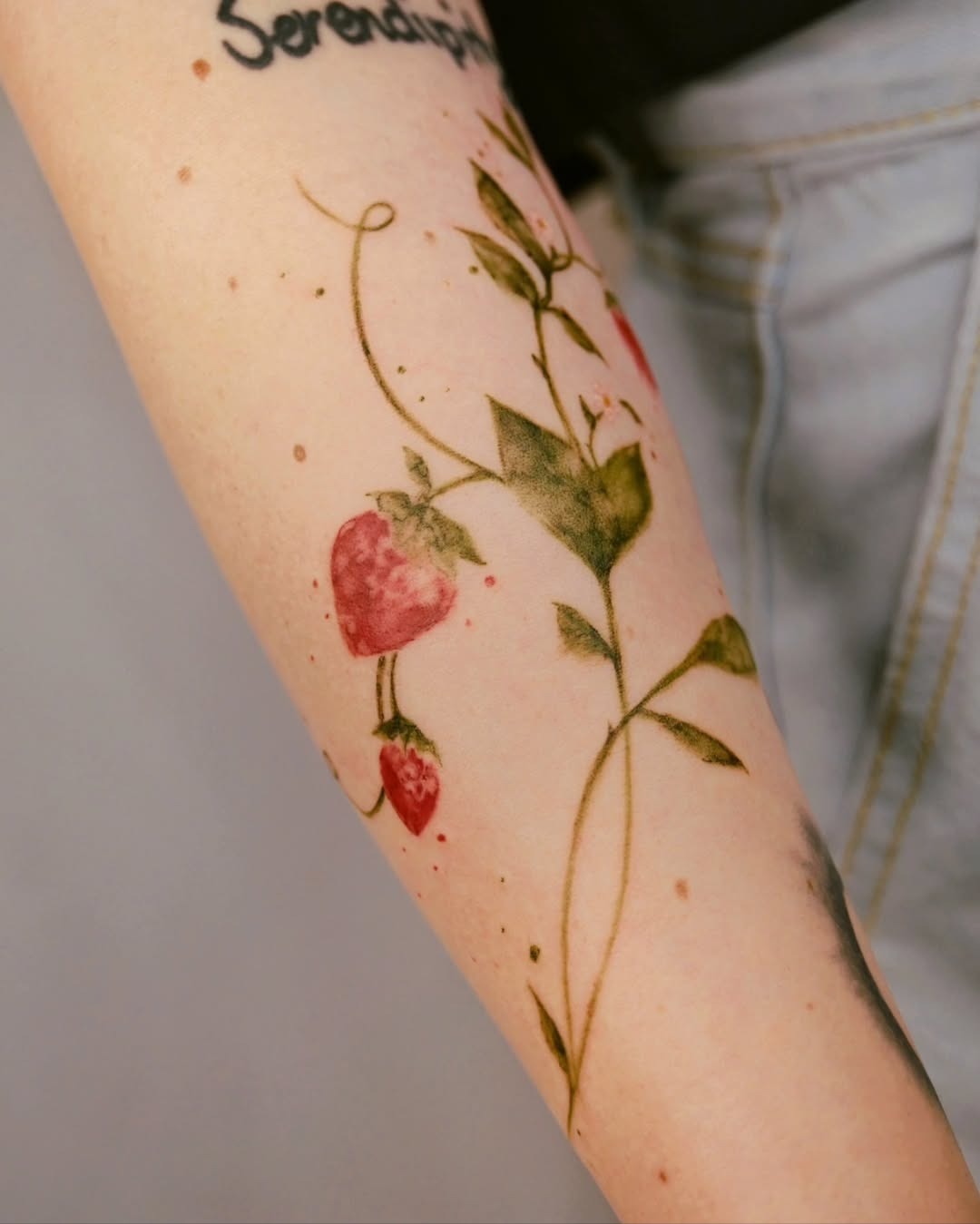 Vibrant Strawberry Tattoo with Floral Elements Tattoo Design