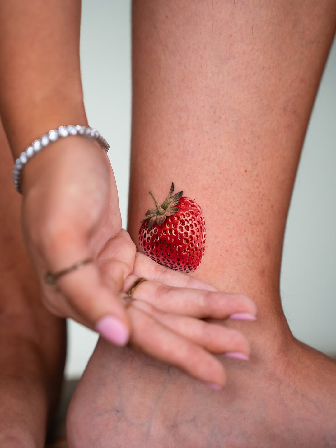 Vivid Strawberry Tattoo on Ankle Tattoo Design