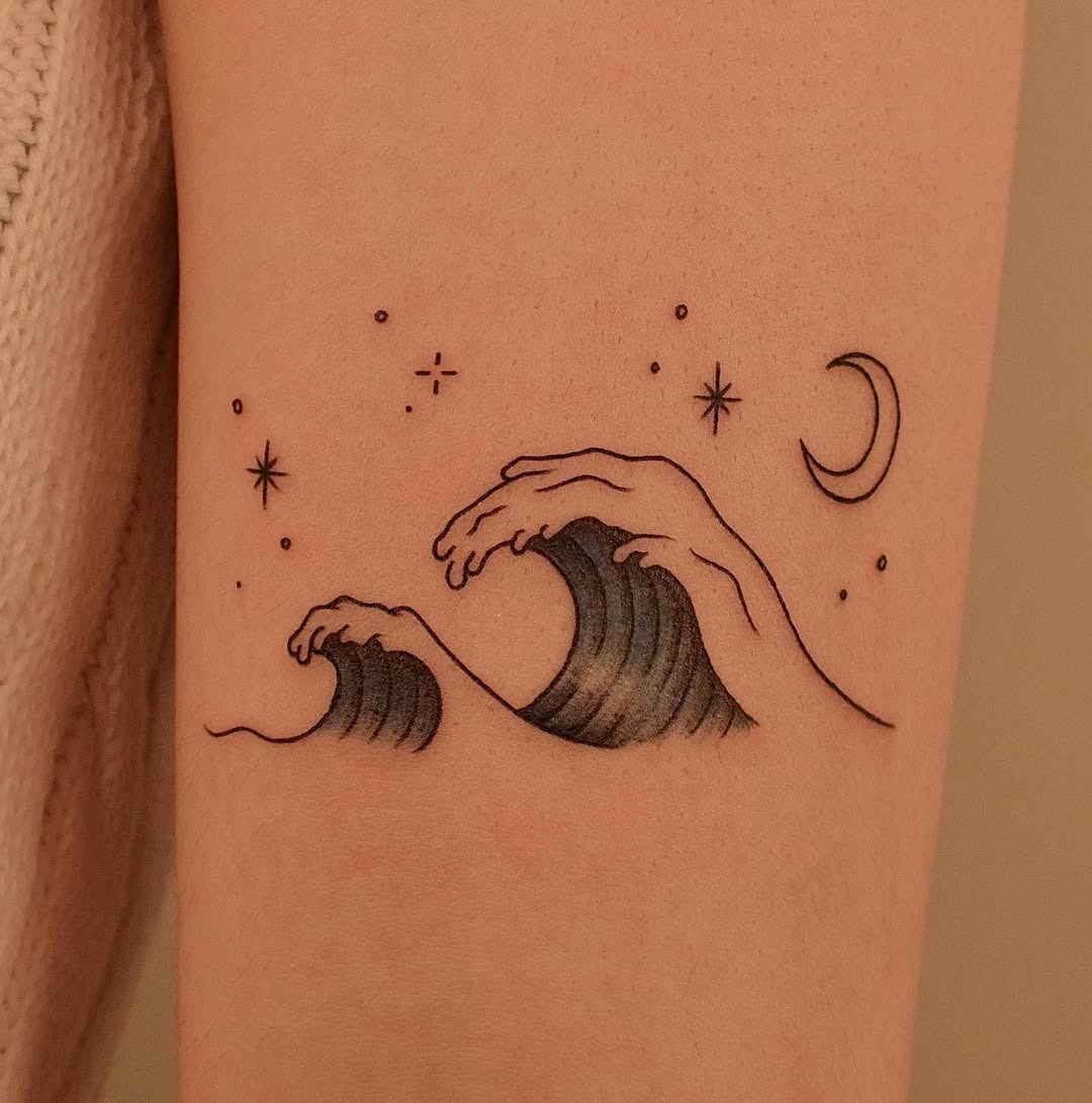 Meaningful strength tattoo featuring elegant waves and celestial elements unite beautifully in bold black ink