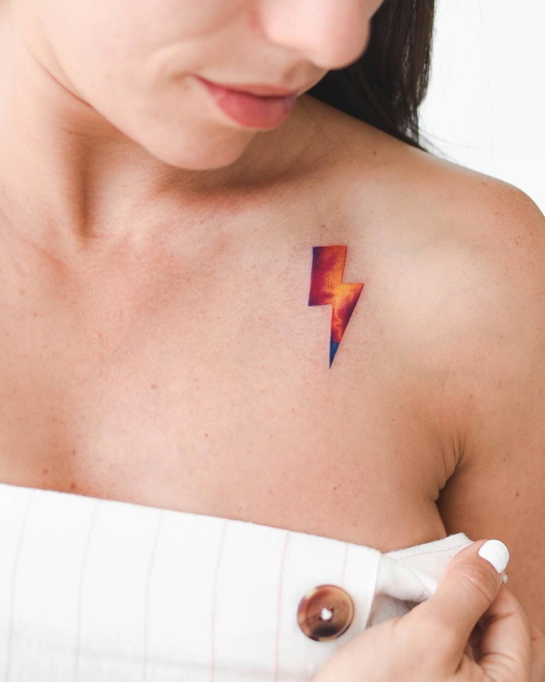 Meaningful strength tattoo featuring vibrant lightning bolt showcasing inner strength in bold black ink