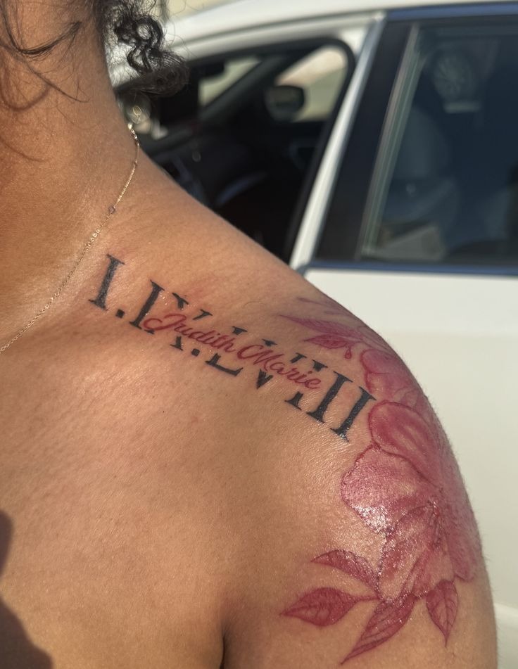 Shoulder Roman Numerals with Red Name and Flowers Tattoo Design