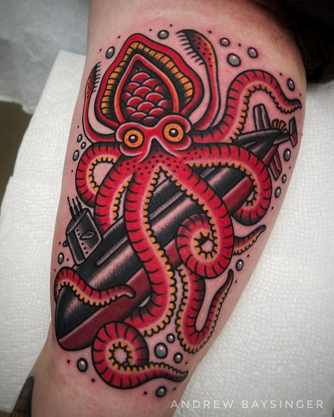 Bold octopus wraps around a submarine tattoo. Tattoo Design