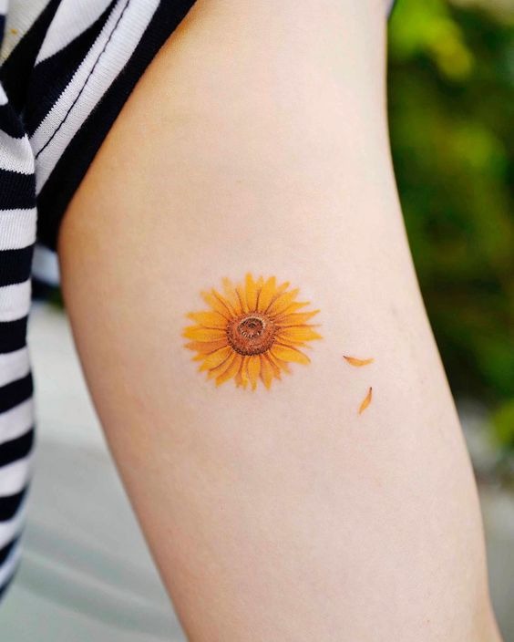 Delicate Colored Sunflower Tattoo Ideas with Floating Petals Tattoo Design