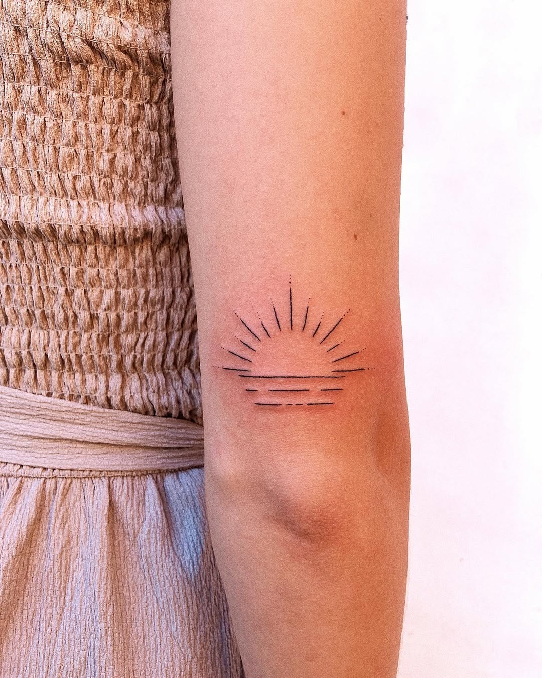 Elegant minimalist sunrise tattoo on the arm Tattoo Design