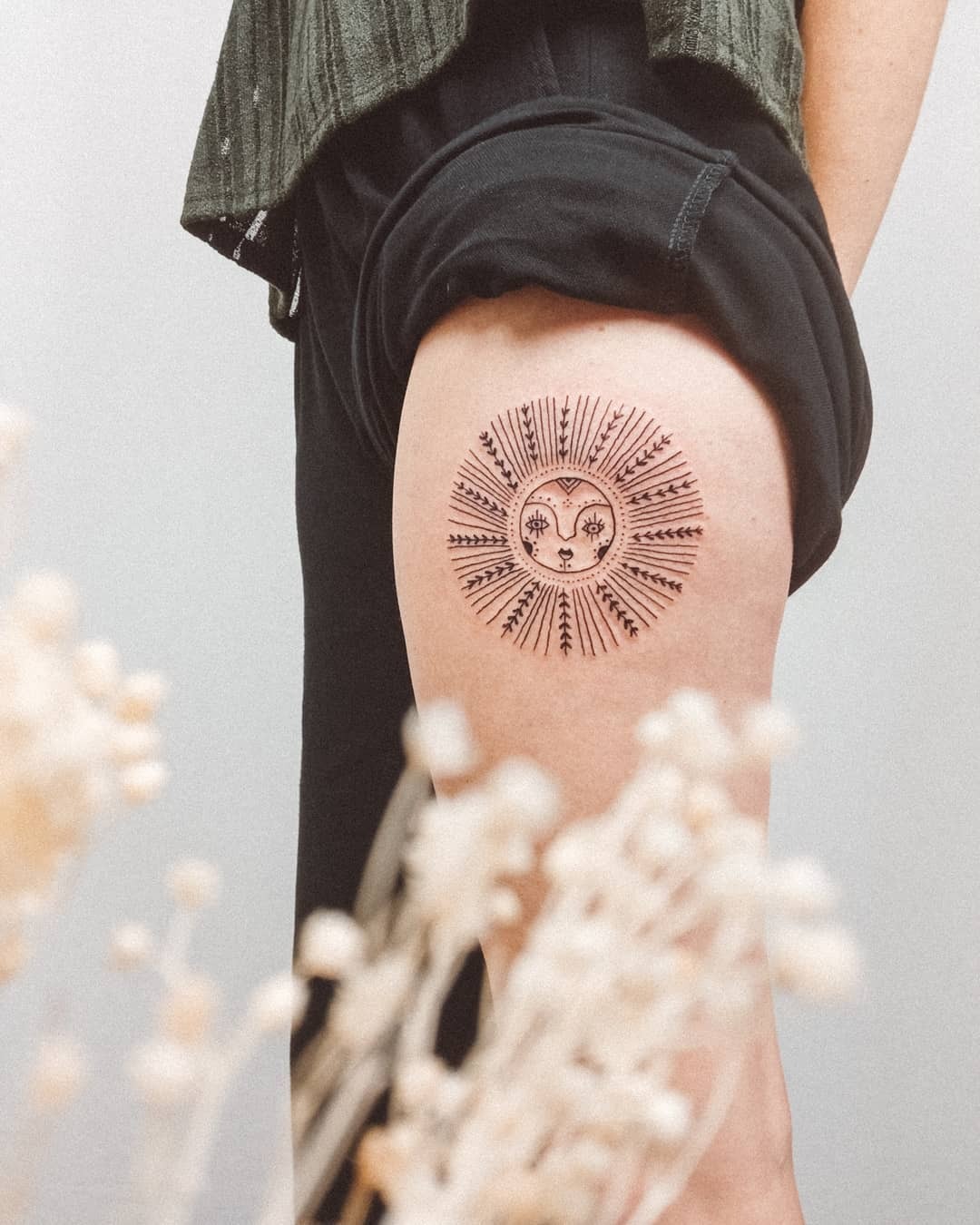Vibrant sunrise tattoo on thigh accentuated Tattoo Design