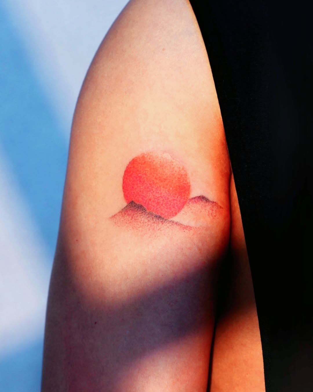 Vibrant sunrise tattoo with soft mountain silhouettes Tattoo Design