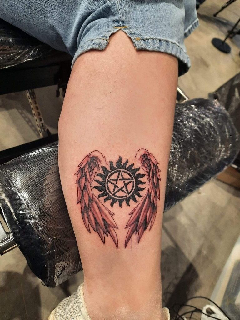 Bold Forearm Wings Tattoo Design