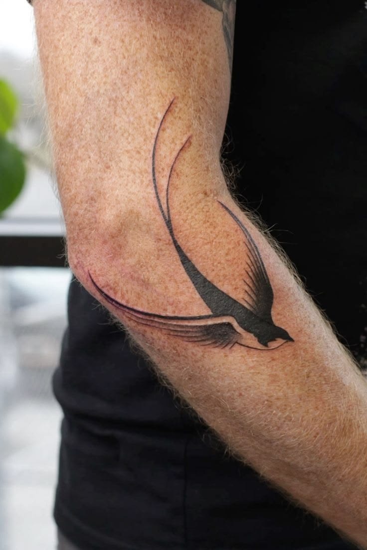 Minimalist Black Swallow on the Elbow Tattoo Design