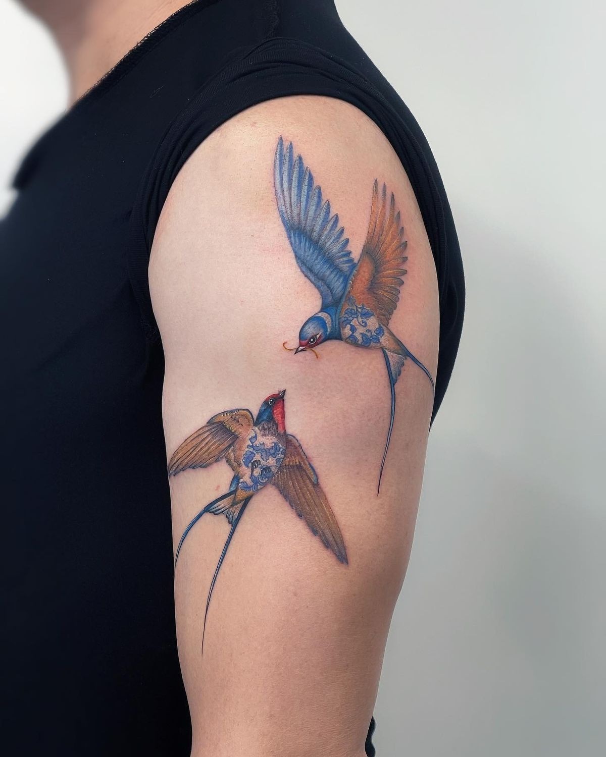 Two Ornamental Color Swallows on the Upper Arm Tattoo Design