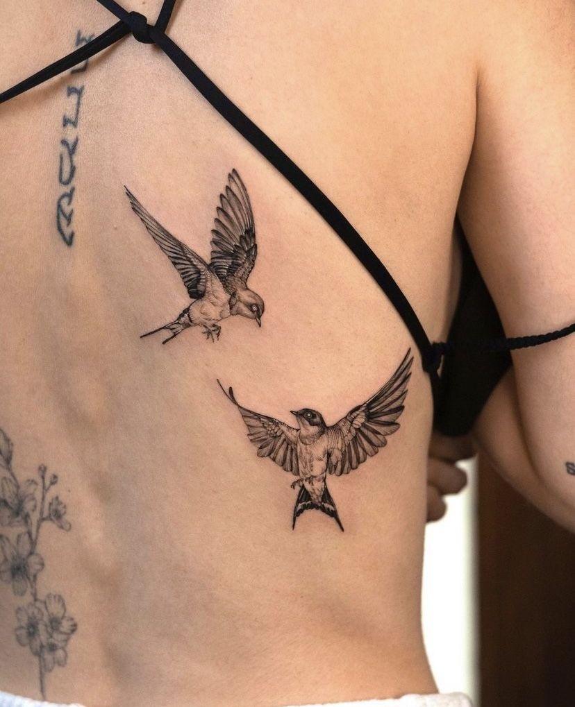 Two Realistic Swallows in Flight Tattoo Design