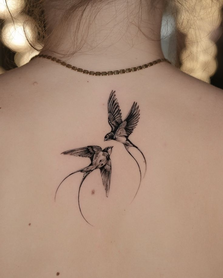 Two Swallows Meeting on the Upper Back Tattoo Design