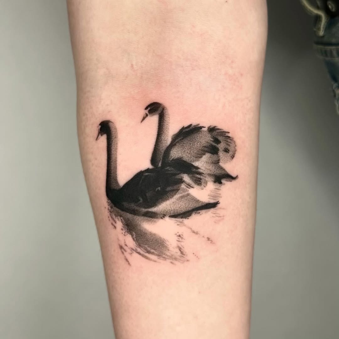 Elegant black swan silhouettes in motion Tattoo Design
