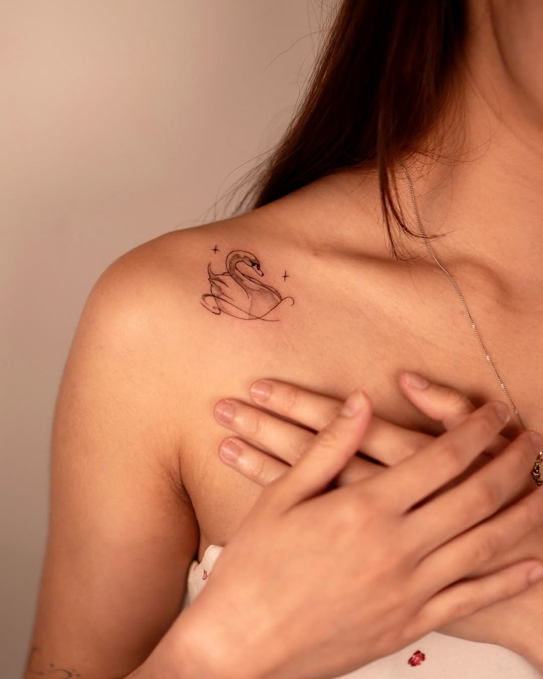 Elegant swan tattoo on a woman’s shoulder Tattoo Design