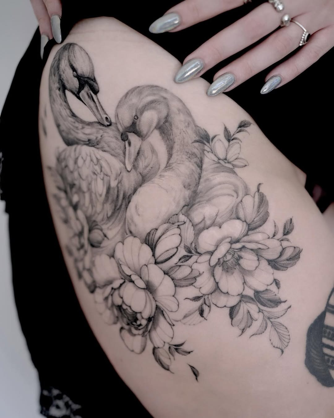 Elegant swan tattoo surrounded by floral elements Tattoo Design
