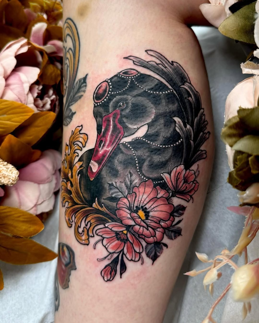 Elegant swan tattoo surrounded by floral elements Tattoo Design