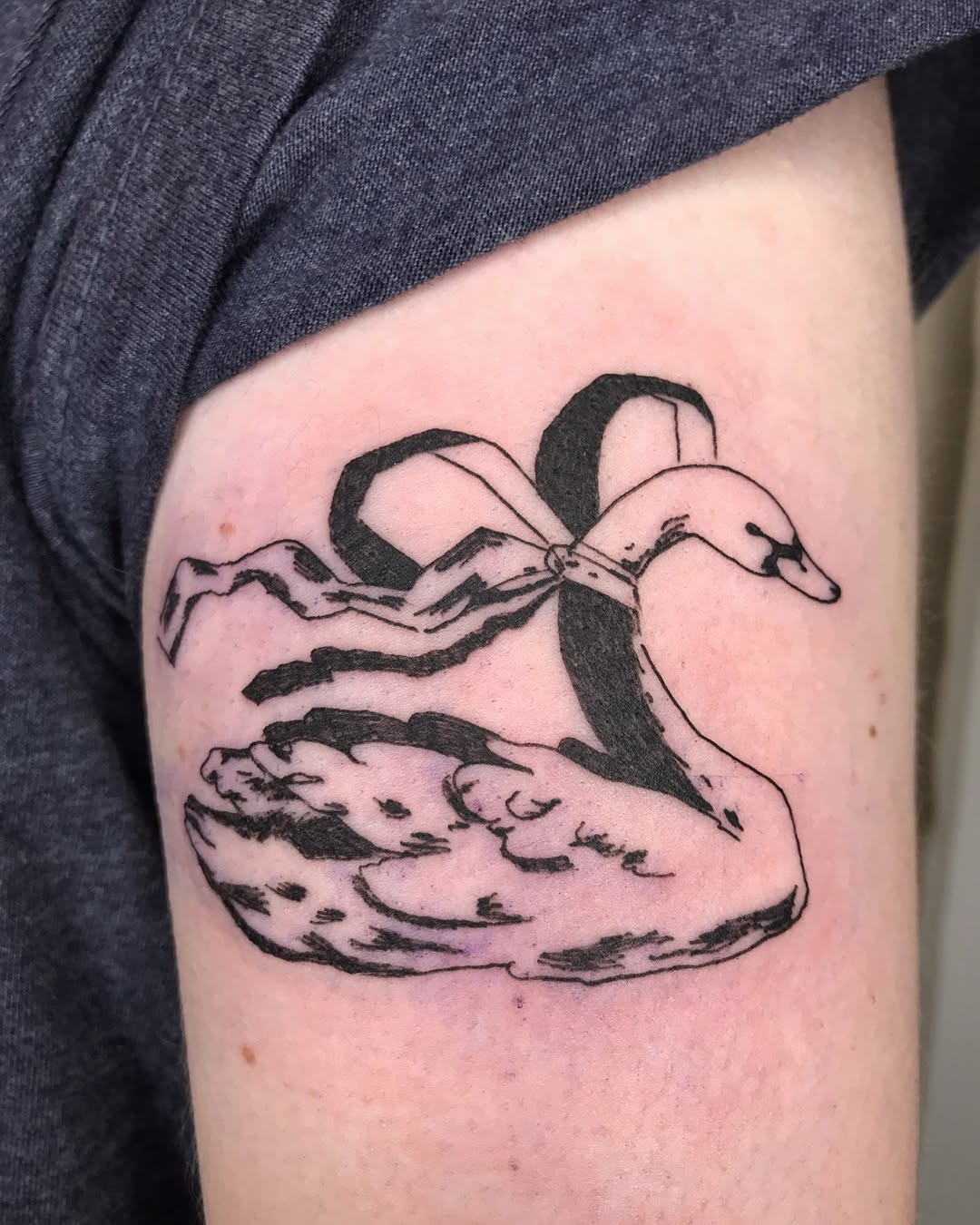 Elegant swan tattoo with a delicate ribbon Tattoo Design