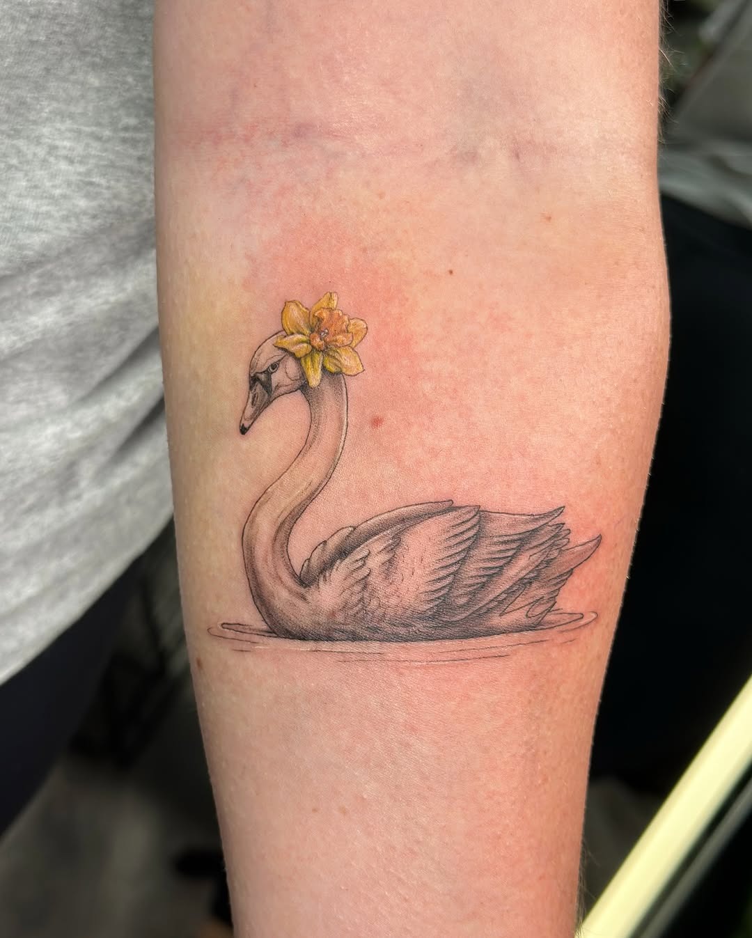 Elegant swan tattoo with floral accents Tattoo Design