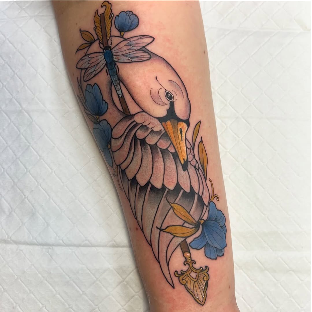 Elegant swan tattoo with floral accents Tattoo Design