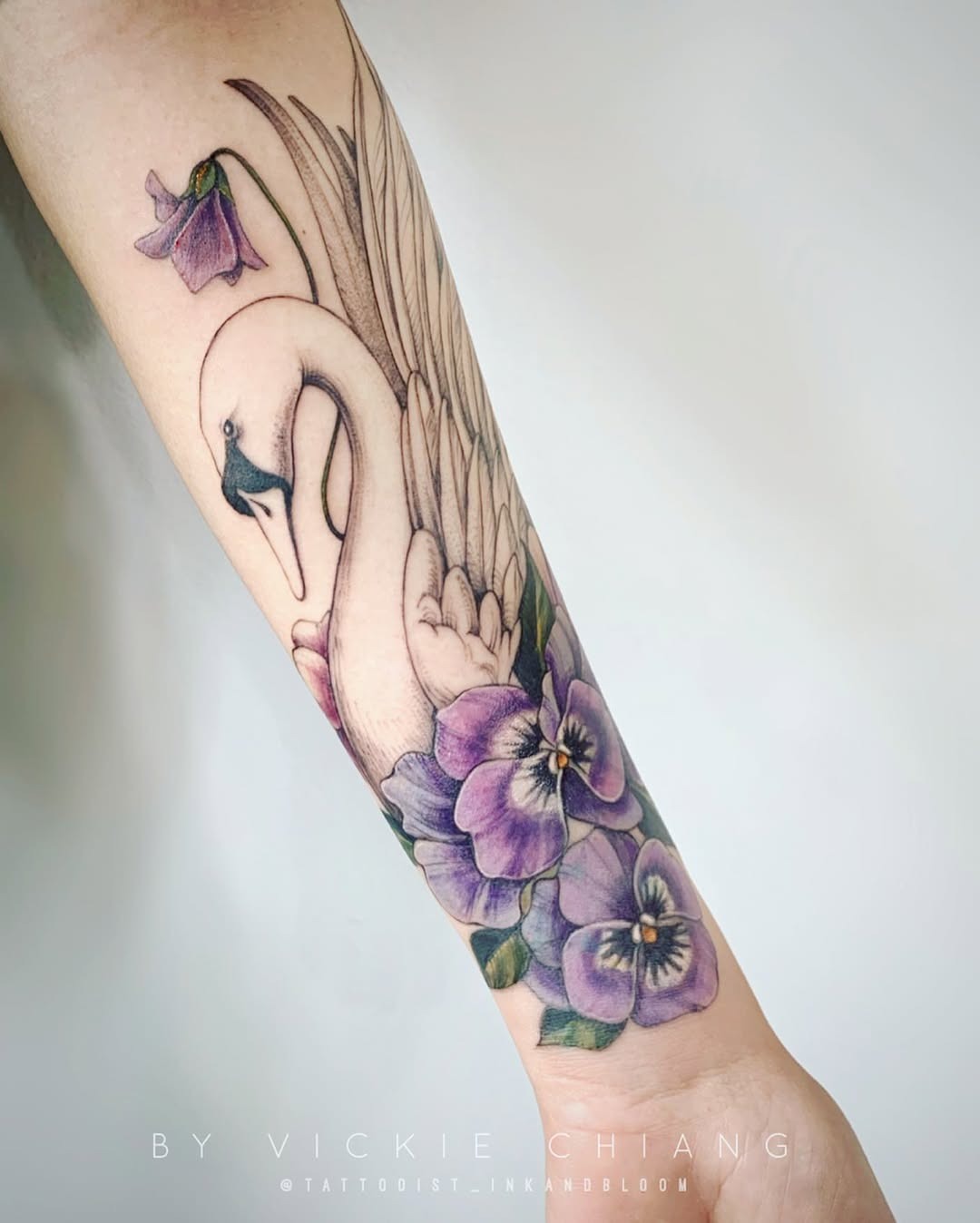 Elegant swan tattoo with floral accents Tattoo Design