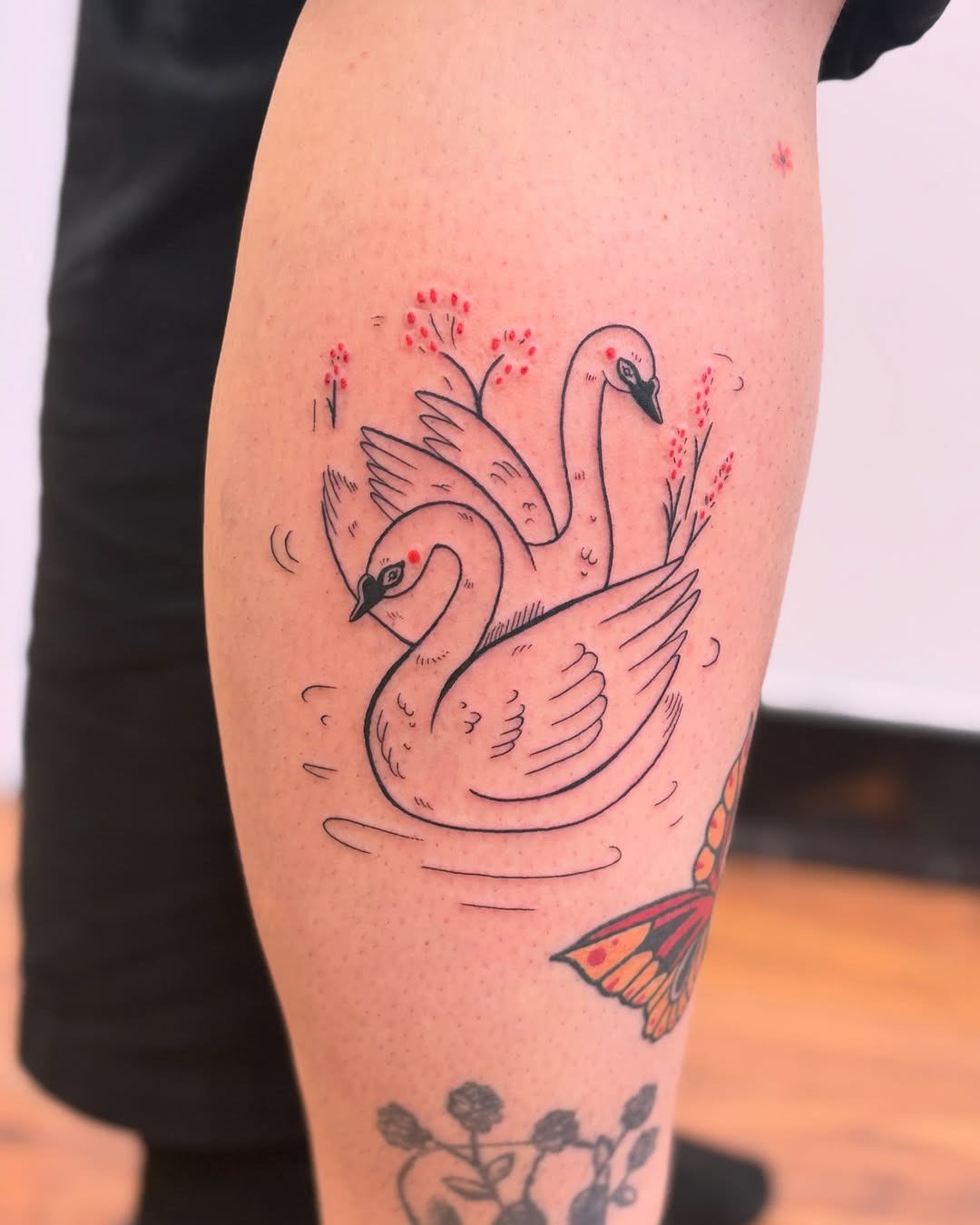 Elegant swan tattoo with floral elements Tattoo Design