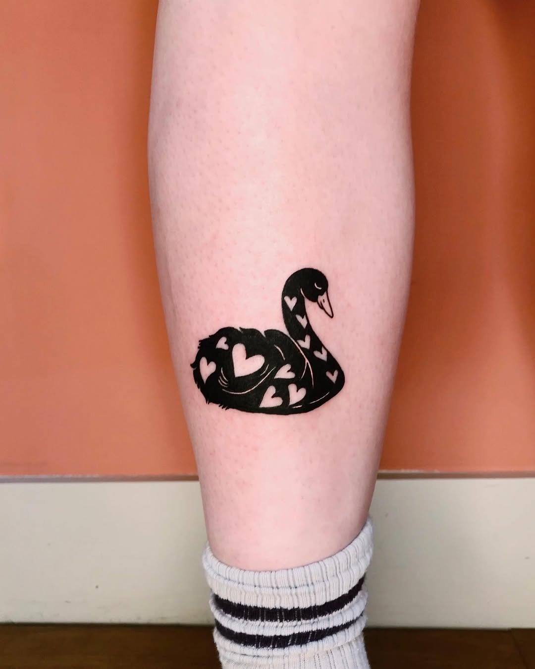 Elegant swan tattoo with heart motifs Tattoo Design