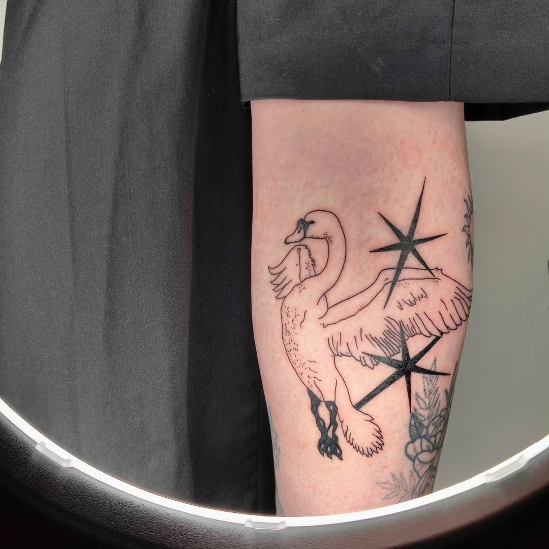 Elegant swan tattoo with striking star details Tattoo Design